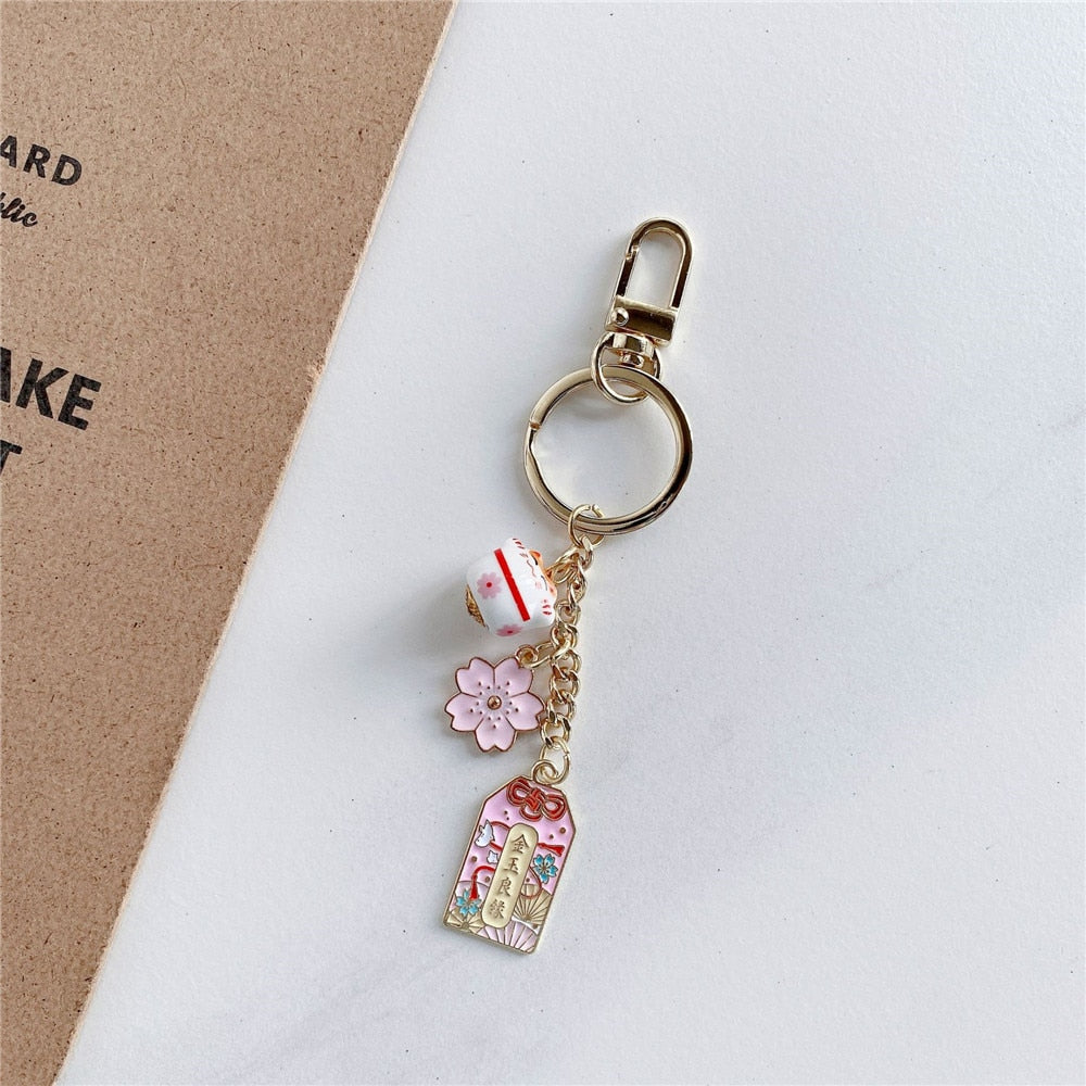 Omamori Sakura Amulet Lucky Cat Keychain sakura Maneki Neko Accessories by The Kawaii Shoppu | The Kawaii Shoppu